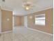 Well-lit living room features tile flooring, neutral walls, a ceiling fan, and a window with blinds at 124 Carolyn Dr, Lakeland, FL 33803