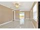 Bright living room with neutral paint, tile floors, ceiling fan, and sliding glass doors to the backyard at 124 Carolyn Dr, Lakeland, FL 33803