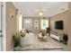Cozy staged living room with neutral walls, indoor plants, area rug, and modern furnishings at 124 Carolyn Dr, Lakeland, FL 33803