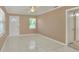 Bright living room featuring tile floors, neutral walls, white trim, and a front door at 124 Carolyn Dr, Lakeland, FL 33803