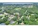 Aerial view of a neighborhood with mature trees and a home with an arrow pointing to it at 1300 Ariana Woods Cir, Auburndale, FL 33823