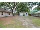 Backyard featuring home, a shed, a wood fence, and mature trees at 1300 Ariana Woods Cir, Auburndale, FL 33823
