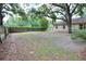 Large backyard with a wood fence and mature trees at 1300 Ariana Woods Cir, Auburndale, FL 33823