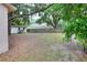 Spacious backyard view featuring a shed, home, and wood fence at 1300 Ariana Woods Cir, Auburndale, FL 33823
