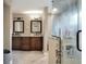 A spacious bathroom boasts double sinks with granite countertops and a luxurious walk-in shower at 1300 Ariana Woods Cir, Auburndale, FL 33823