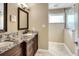 Bathroom boasts granite counters, and sinks, updated fixtures and a glass-enclosed shower at 1300 Ariana Woods Cir, Auburndale, FL 33823