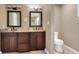 Updated bathroom with and sinks, granite counters, contemporary lighting, and modern fixtures at 1300 Ariana Woods Cir, Auburndale, FL 33823