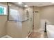 A stunning bathroom features a glass-enclosed shower and a view from the window at 1300 Ariana Woods Cir, Auburndale, FL 33823