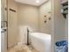 A pristine white bathtub stands as a focal point, complemented by a modern faucet and fixtures at 1300 Ariana Woods Cir, Auburndale, FL 33823