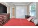 A bright bedroom includes a comfortable bed, a large window, and ample closet space at 1300 Ariana Woods Cir, Auburndale, FL 33823