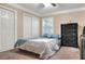 A comfortable bedroom features a bed, window, closet, and dresser at 1300 Ariana Woods Cir, Auburndale, FL 33823