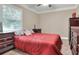 A cozy bedroom features a comfortable bed, a large window, and stylish furnishings at 1300 Ariana Woods Cir, Auburndale, FL 33823