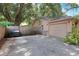 Beige house with a stone accent and a two-car garage at 1300 Ariana Woods Cir, Auburndale, FL 33823