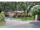 Exterior view of a house with a stone mailbox, well-manicured lawn, and driveway leading to a garage at 1300 Ariana Woods Cir, Auburndale, FL 33823