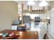 Spacious kitchen featuring white cabinets, stainless steel appliances, a tile backsplash and breakfast table at 1300 Ariana Woods Cir, Auburndale, FL 33823