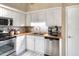 Well-lit kitchen with stainless steel appliances, white cabinets, a tile backsplash and wood countertops at 1300 Ariana Woods Cir, Auburndale, FL 33823
