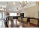 Open floor plan combining the living room and dining area, enhanced by hardwood floors and neutral paint at 1300 Ariana Woods Cir, Auburndale, FL 33823