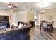 Open-concept living room and dining area with hardwood floors, comfortable seating, and natural light at 1300 Ariana Woods Cir, Auburndale, FL 33823