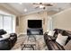 Living room featuring a television, fireplace, and ample seating with modern flooring and lighting at 1300 Ariana Woods Cir, Auburndale, FL 33823