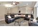 Living room with a large sectional sofa, a glass table, and an open layout into the dining area at 1300 Ariana Woods Cir, Auburndale, FL 33823
