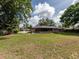 Back exterior of brick home with screened in porch and large backyard at 1315 Costine Dr, Lakeland, FL 33809