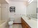 This bathroom features a large mirror, a wood vanity, and a bathtub with white tile at 1315 Costine Dr, Lakeland, FL 33809