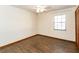 This bedroom features wood floors, a window with blinds, and neutral walls at 1315 Costine Dr, Lakeland, FL 33809