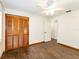 This bedroom features wood floors, a ceiling fan, and a closet with folding doors at 1315 Costine Dr, Lakeland, FL 33809