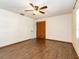 This bedroom features wood floors, a closet, and a ceiling fan at 1315 Costine Dr, Lakeland, FL 33809
