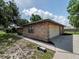 Brick home featuring a two-car garage, manicured landscaping and a paved driveway at 1315 Costine Dr, Lakeland, FL 33809