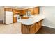 Lovely kitchen area features ample wood cabinets, stainless appliances, and a convenient breakfast bar at 1315 Costine Dr, Lakeland, FL 33809