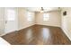 Inviting living room features wood floors, a ceiling fan, and lots of natural light at 1315 Costine Dr, Lakeland, FL 33809