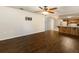 Open-concept living room with wood flooring and a view into the spacious kitchen at 1315 Costine Dr, Lakeland, FL 33809