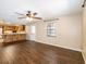 Spacious living room with wood floors, ceiling fan, and kitchen access at 1315 Costine Dr, Lakeland, FL 33809