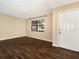 Well-lit living room featuring wood-look tile flooring, neutral paint, and a window at 1315 Costine Dr, Lakeland, FL 33809