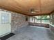 This covered patio has a brick wall and a ceiling fan at 1315 Costine Dr, Lakeland, FL 33809