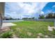 Large fenced backyard featuring green grass and a brick paver patio, perfect for outdoor enjoyment at 133 Cloverbrook Trl, Davenport, FL 33837