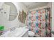 Nautical themed bathroom featuring a decorative mirror and patterned shower curtain at 133 Cloverbrook Trl, Davenport, FL 33837