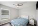 Inviting bedroom with wood-look flooring, ceiling fan, and bright natural light at 133 Cloverbrook Trl, Davenport, FL 33837