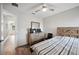 Comfortable bedroom with wood-look floors, ceiling fan, and a dresser at 133 Cloverbrook Trl, Davenport, FL 33837