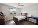 Bright bedroom with ceiling fan, window and wood-look flooring for a modern aesthetic at 133 Cloverbrook Trl, Davenport, FL 33837