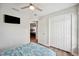 Bright bedroom view featuring wood-look floors, closet and ceiling fan at 133 Cloverbrook Trl, Davenport, FL 33837