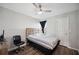 This bedroom features wood-look flooring, a ceiling fan, and natural light at 133 Cloverbrook Trl, Davenport, FL 33837