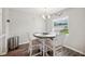 Cozy dining area with round table, white chairs, and natural light from window at 133 Cloverbrook Trl, Davenport, FL 33837