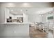Open dining area with white table and chairs, adjacent to kitchen bar at 133 Cloverbrook Trl, Davenport, FL 33837