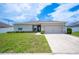 Charming single-story home with manicured lawn and two-car garage at 133 Cloverbrook Trl, Davenport, FL 33837