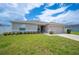 Well-maintained single-story home with green lawn and attached two-car garage at 133 Cloverbrook Trl, Davenport, FL 33837