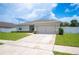 Inviting single-story home with driveway and attached two-car garage at 133 Cloverbrook Trl, Davenport, FL 33837
