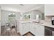 Kitchen with stainless dishwasher and granite countertops adjoins the dining area at 133 Cloverbrook Trl, Davenport, FL 33837