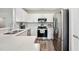 Well-lit kitchen features stainless steel appliances and white cabinetry at 133 Cloverbrook Trl, Davenport, FL 33837